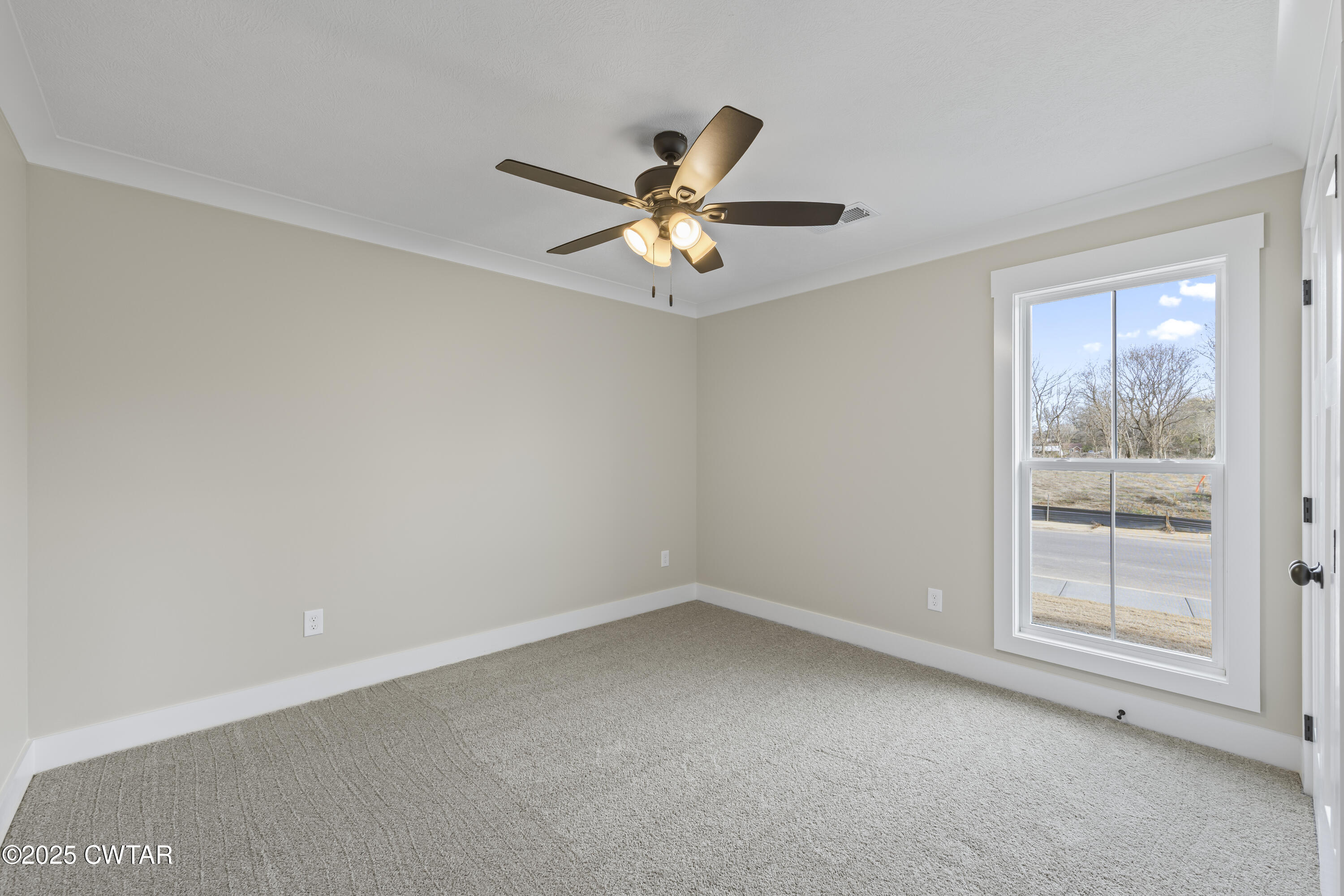 5 Easington Cove Jackson, TN 38305 - Photo 15 of 17 an empty room with a window and a fan