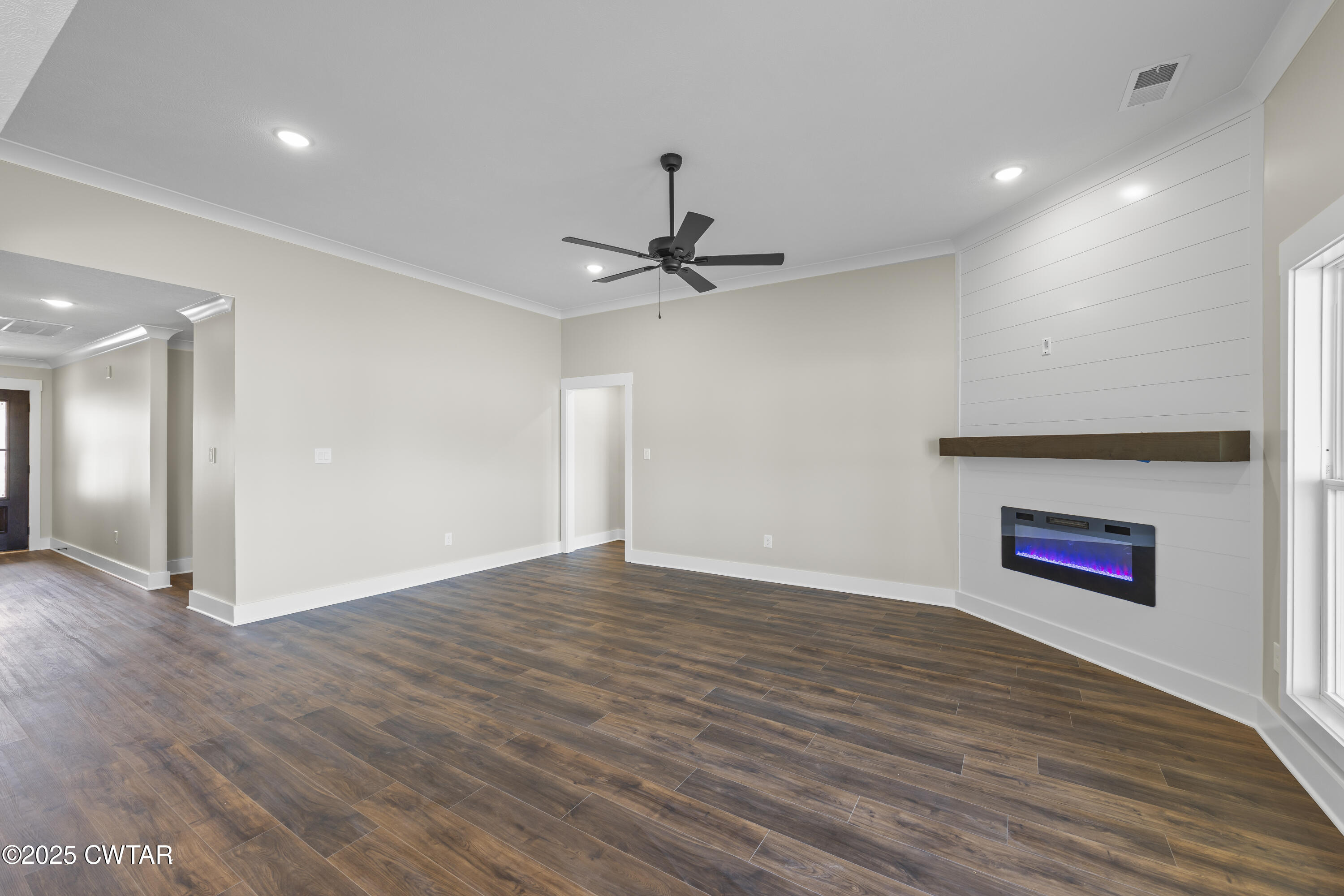 5 Easington Cove Jackson, TN 38305 - Photo 4 of 17 a view of an empty room with a ceiling fan and wooden floor