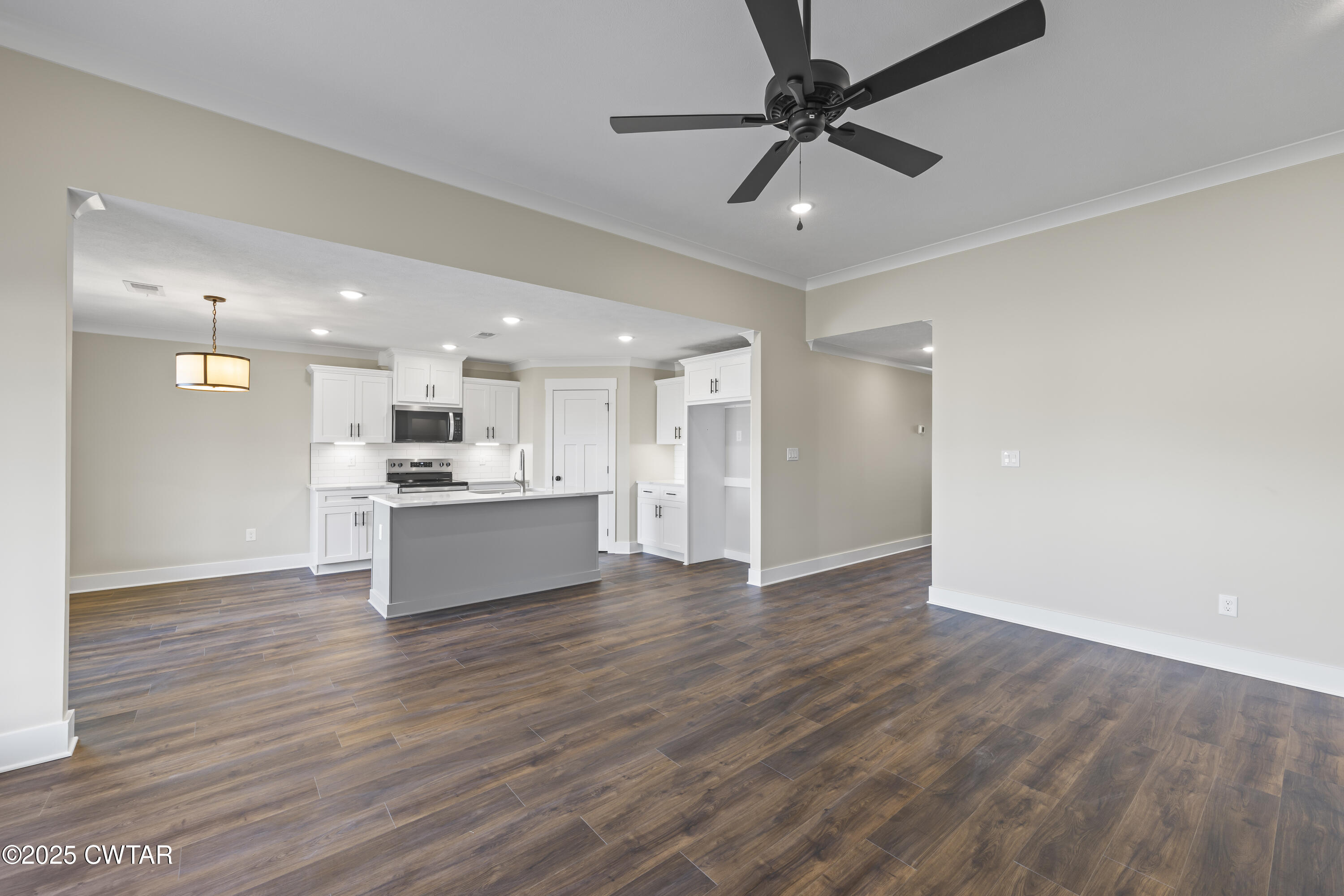 5 Easington Cove Jackson, TN 38305 - Photo 5 of 17 a view of kitchen with kitchen island wooden floor center island and stainless steel appliances
