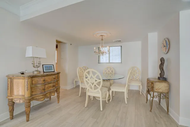 a view of a dining room with furniture wooden floor and chandelier
