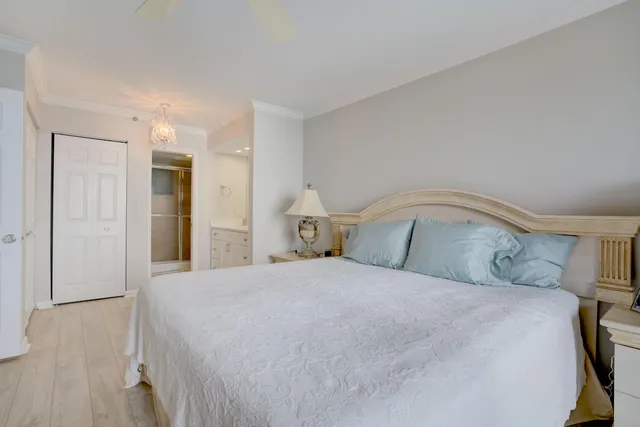 a bedroom with a large bed and a flat tv screen on dresser