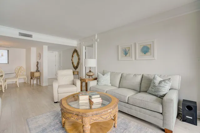 a living room with furniture and a dining table