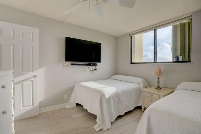 a bedroom with two beds and a window