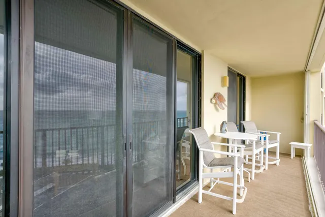 a balcony with table and chairs
