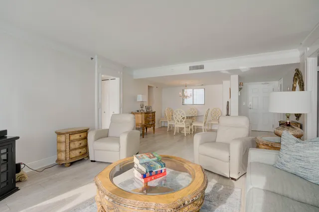 a living room with furniture and a dining table