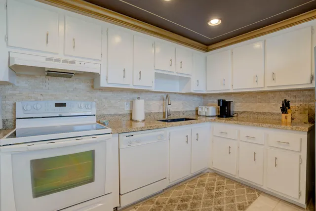 a kitchen with cabinets appliances and a counter space