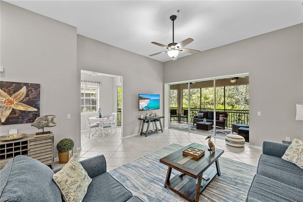 3975 Deer Crossing Court, Unit 201 Naples, FL 34114 - Photo 11 of 35 a living room with furniture and a window