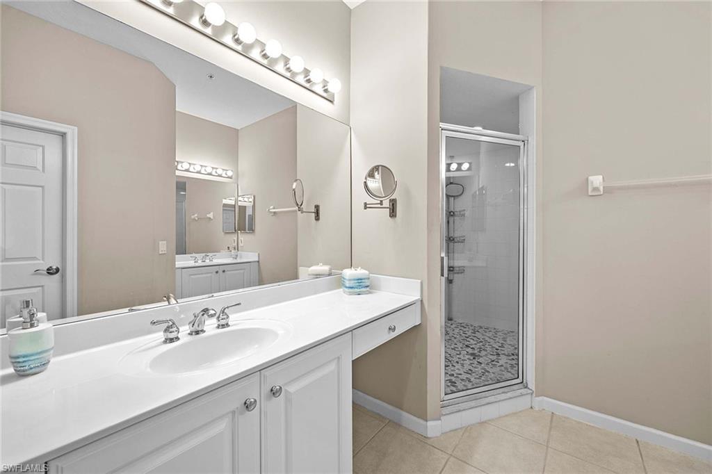 3975 Deer Crossing Court, Unit 201 Naples, FL 34114 - Photo 18 of 35 a bathroom with a sink and a mirror
