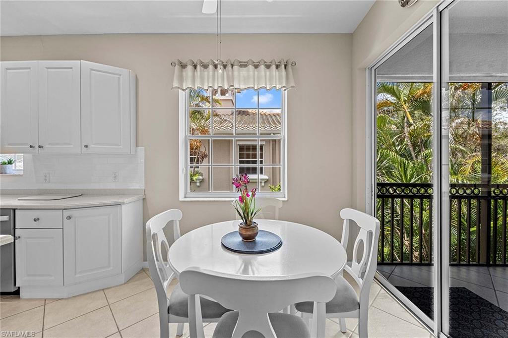 3975 Deer Crossing Court, Unit 201 Naples, FL 34114 - Photo 19 of 35 a dining room with furniture a rug and a window