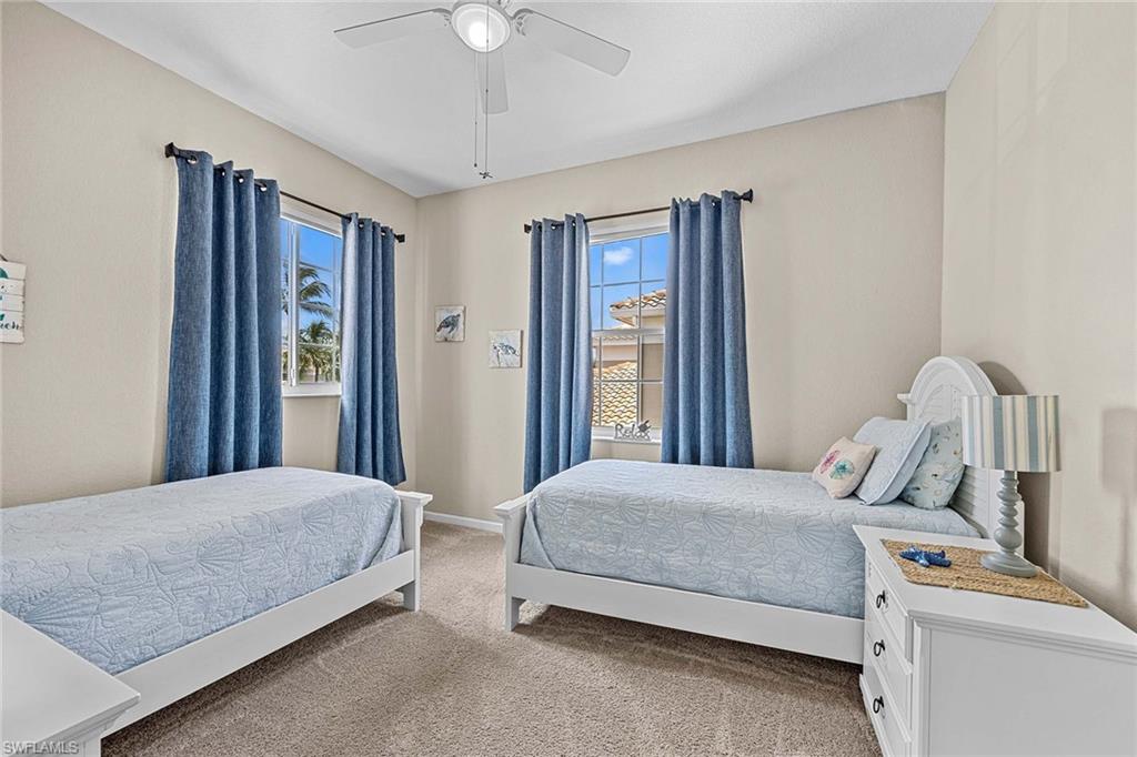 3975 Deer Crossing Court, Unit 201 Naples, FL 34114 - Photo 20 of 35 a bedroom with a bed and a dresser