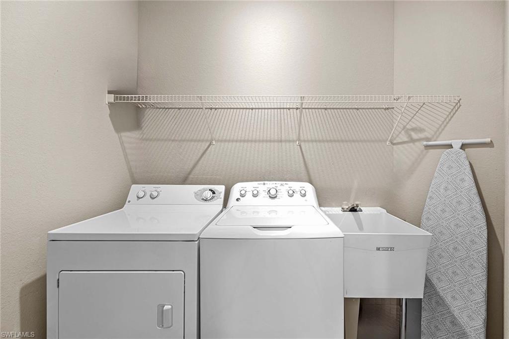 3975 Deer Crossing Court, Unit 201 Naples, FL 34114 - Photo 23 of 35 a utility room with dryer and washer