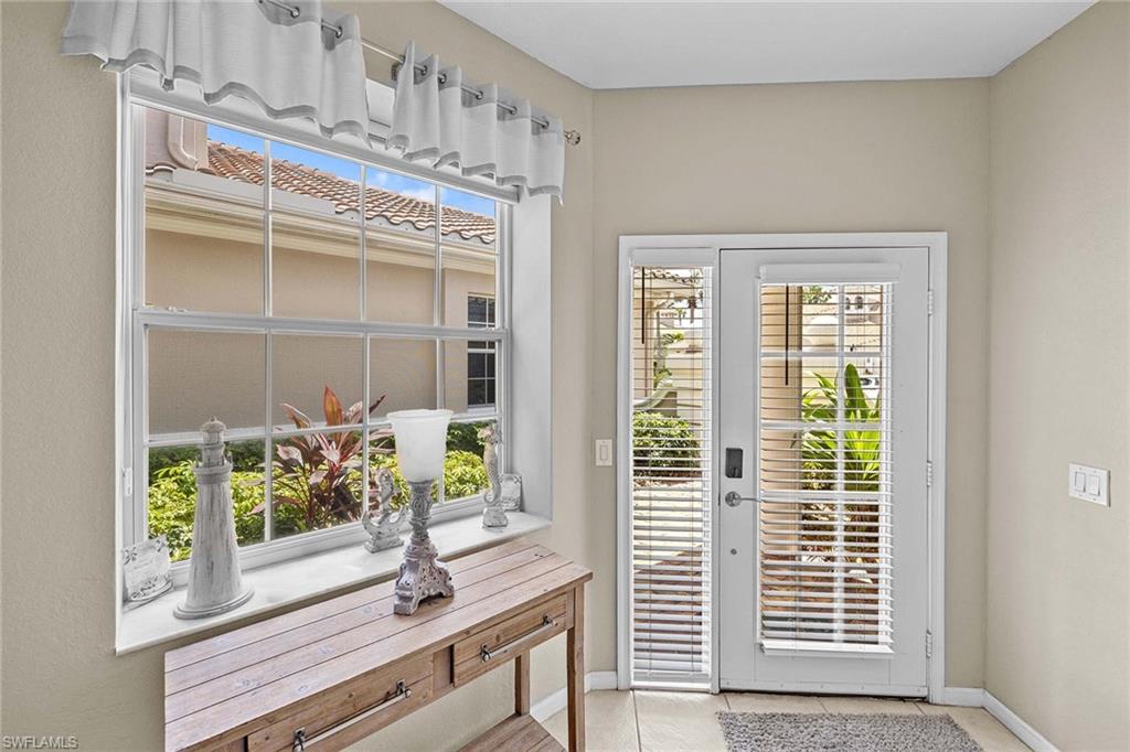 3975 Deer Crossing Court, Unit 201 Naples, FL 34114 - Photo 6 of 35 a view of a living room and balcony