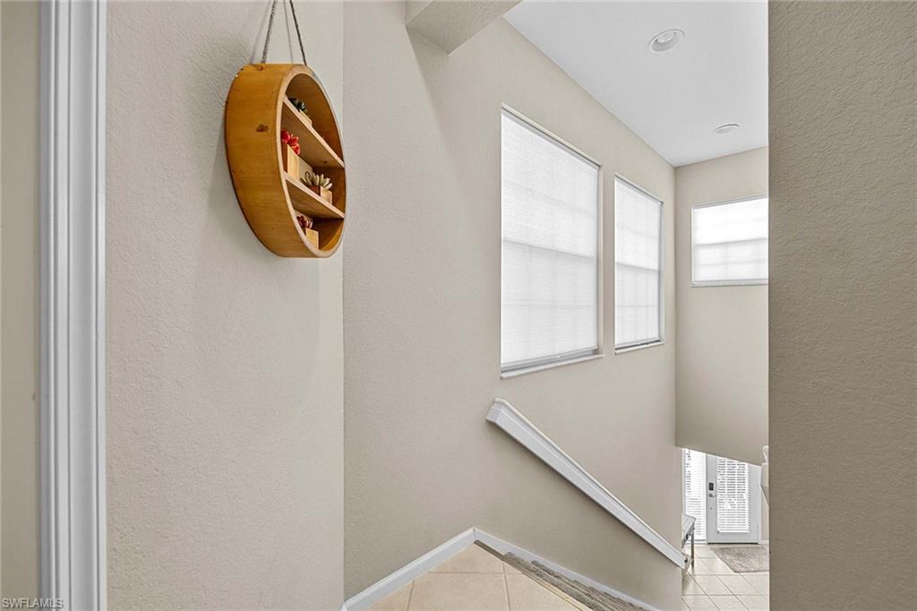 3975 Deer Crossing Court, Unit 201 Naples, FL 34114 - Photo 7 of 35 a view of a hallway with windows