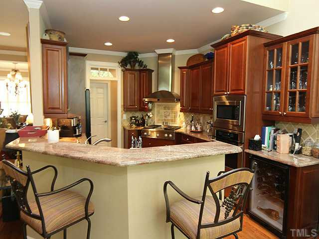 Beautiful kitchen features "upgrade" granite counters with tile backsplash, stainless appliances including wine fridge. Kitchen