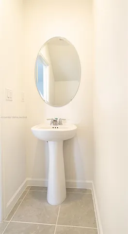 a bathroom with a sink mirror and toilet