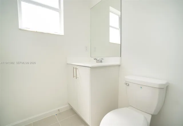 a bathroom with a toilet a sink and a mirror