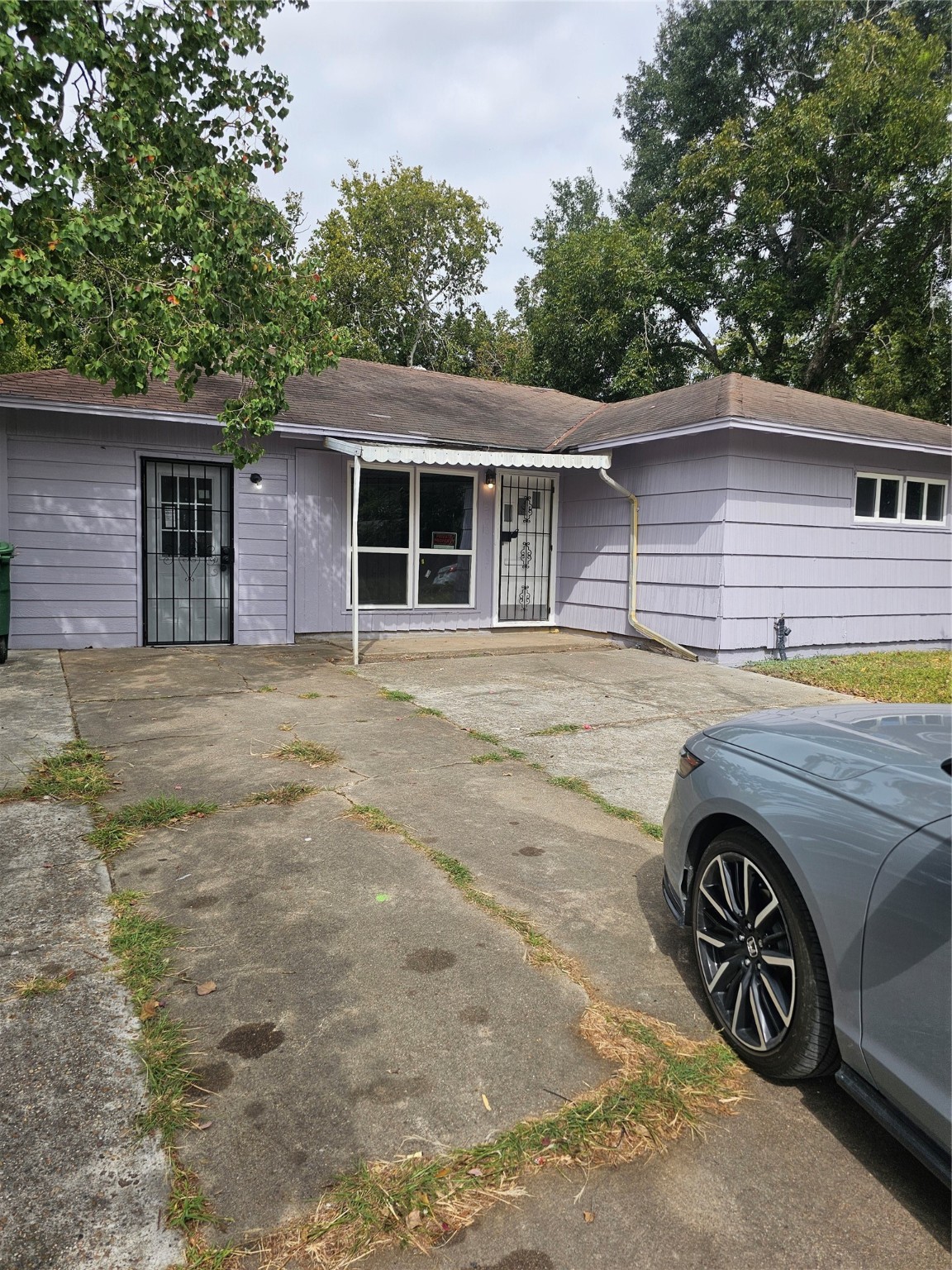 5703 Belneath Street Houston, TX 77033 - Photo 1 of 21 a front view of a house with a garden