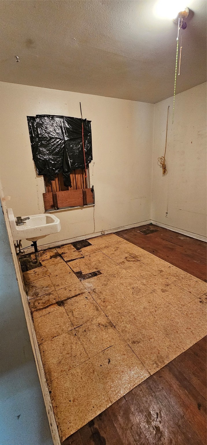 5703 Belneath Street Houston, TX 77033 - Photo 8 of 21 a view of a wooden floor with utility room