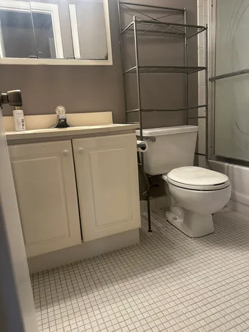 a bathroom with a sink a toilet and a shower