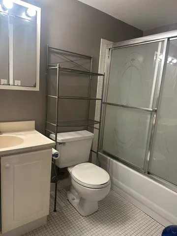 a white toilet sitting next to a shower