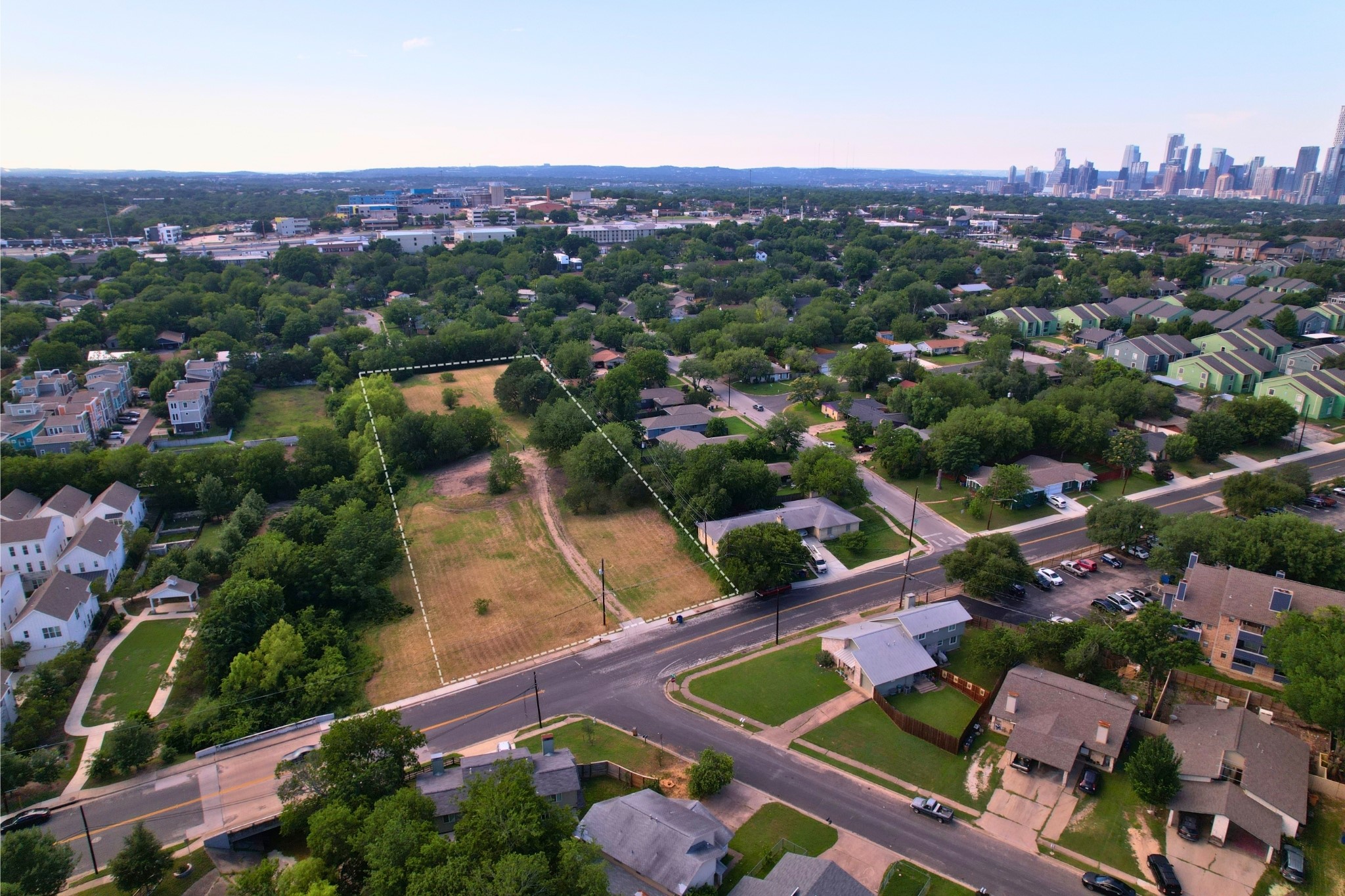 2610-2606 Metcalfe Road Austin, TX 78741 - Photo 17 of 20 A prime development opportunity with cleared lots awaiting your vision, set against a distant cityscape.