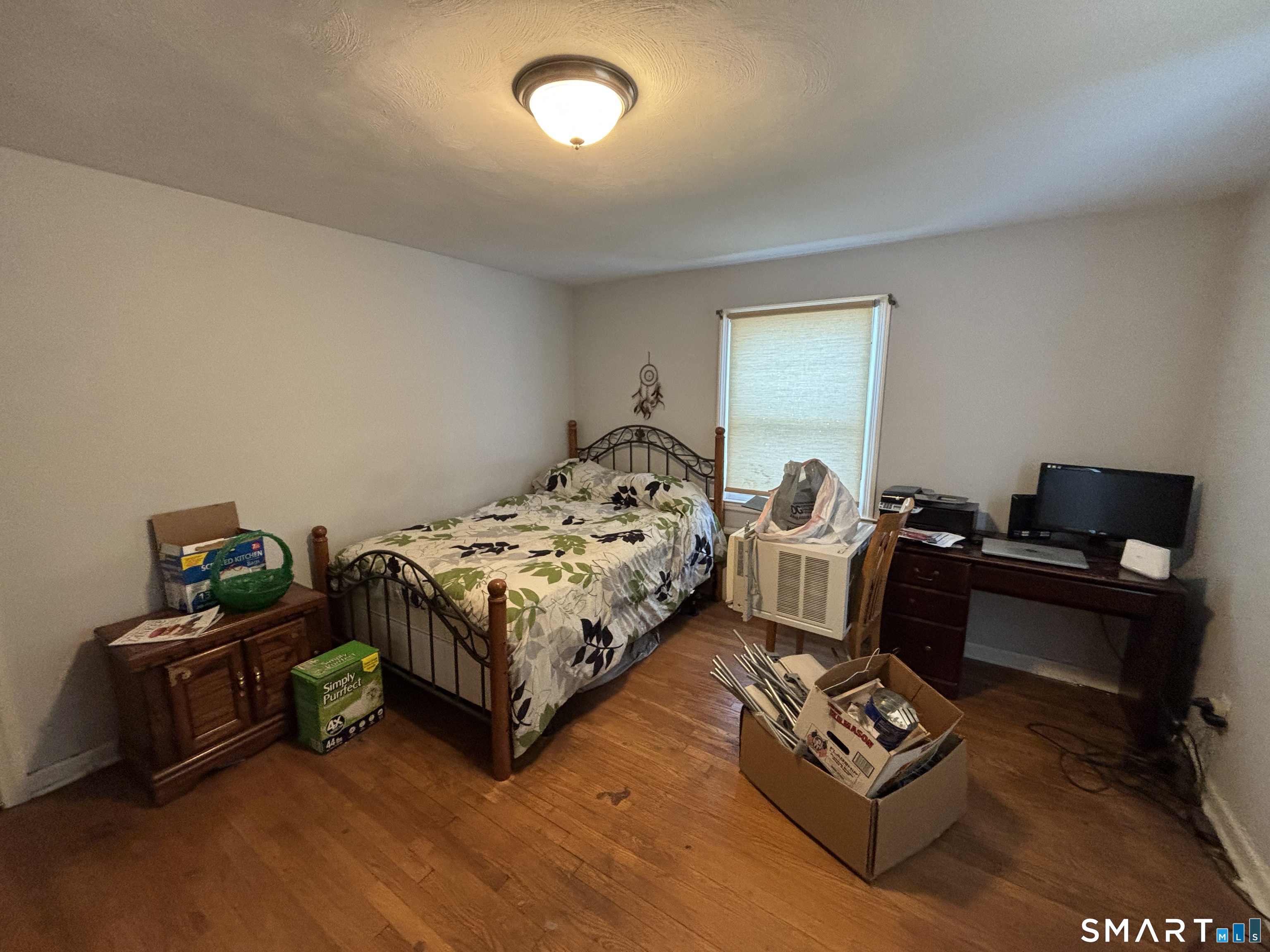 519 Prospect Street Wethersfield, CT 06109 - Photo 12 of 24 a spacious bedroom with a bed and a couch