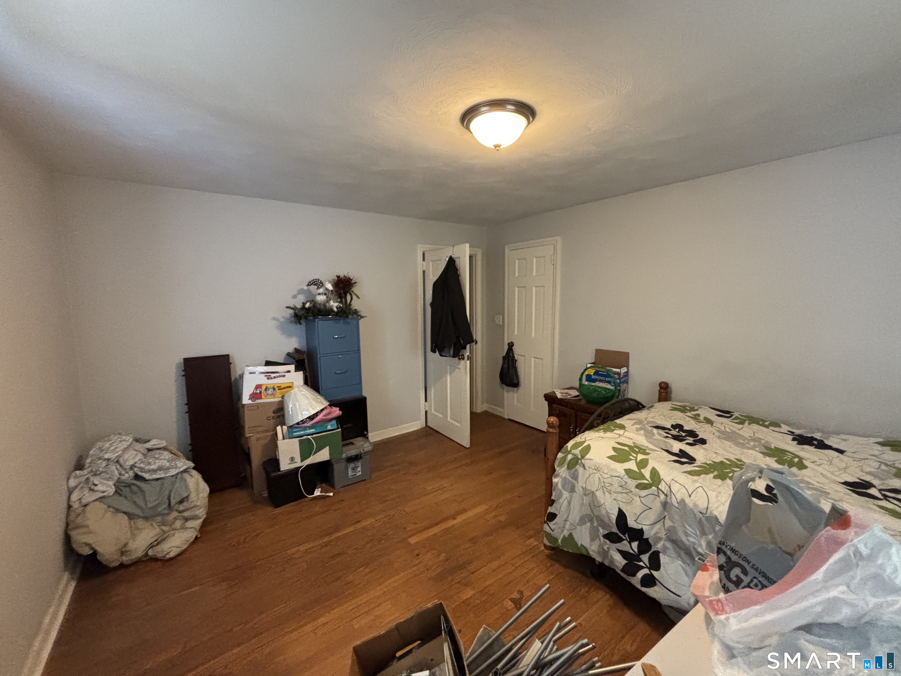 519 Prospect Street Wethersfield, CT 06109 - Photo 13 of 24 a bedroom with a bed and wooden floor