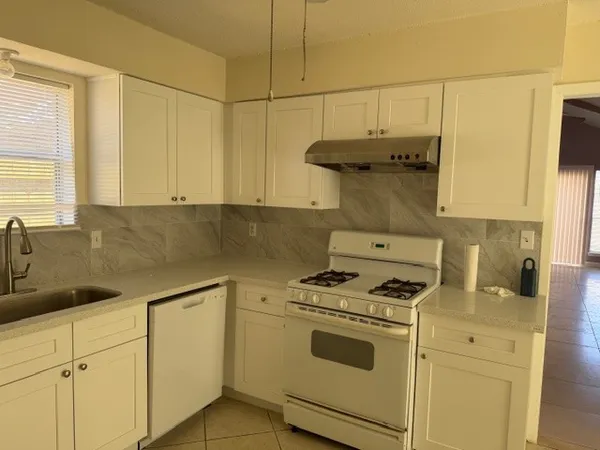 a kitchen with cabinets and appliances