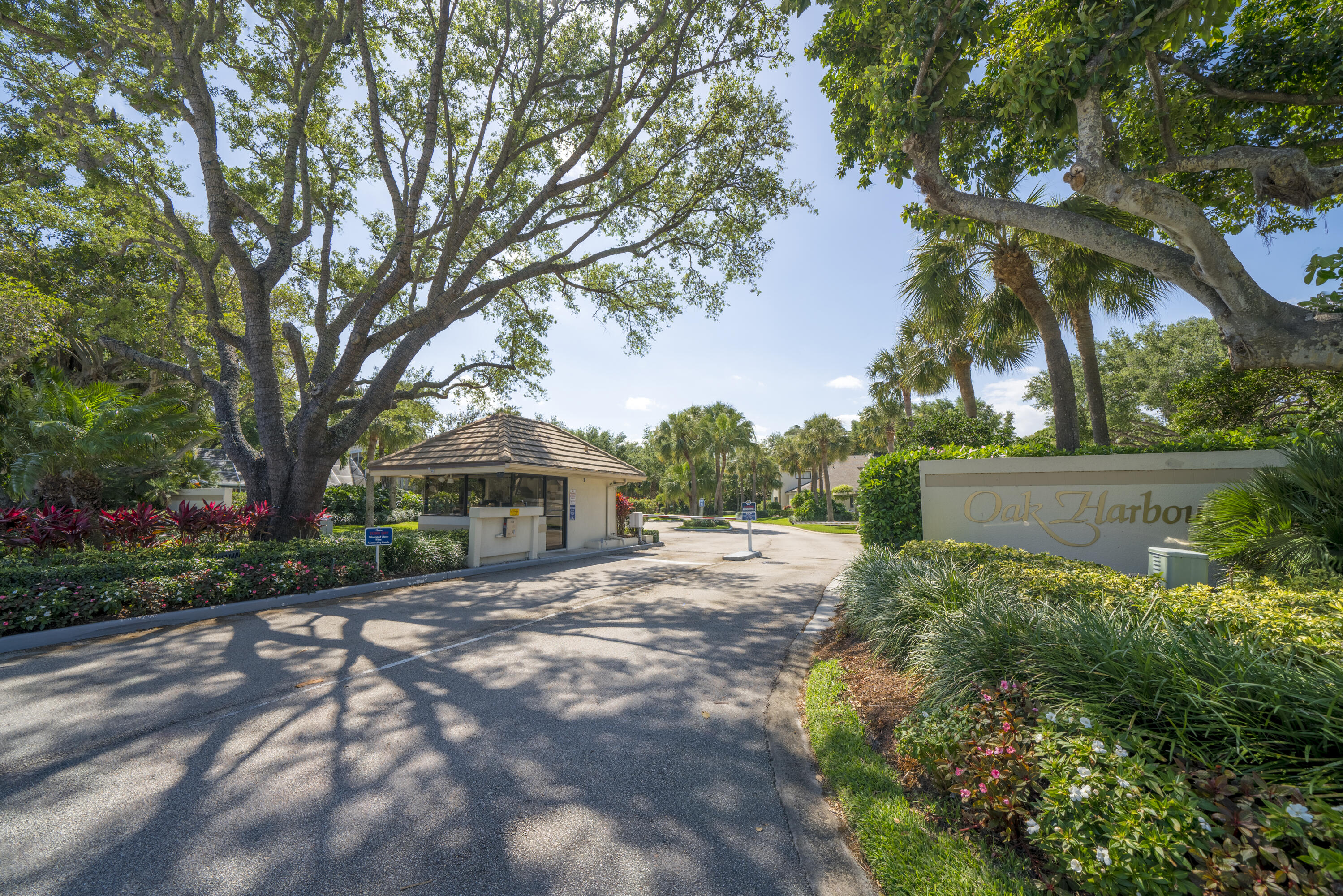 B-9 Oak Harbour Drive Juno Beach, FL 33408 - Photo 13 of 14 a front view of a house with a yard and shrubs