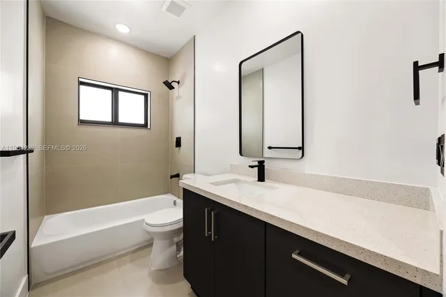 a bathroom with a sink a toilet and a bathtub