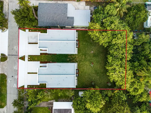 an aerial view of residential houses with city view