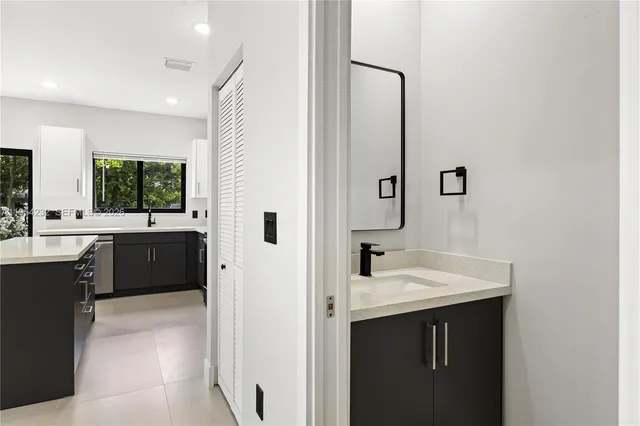 a bathroom with a sink a mirror and a bathtub
