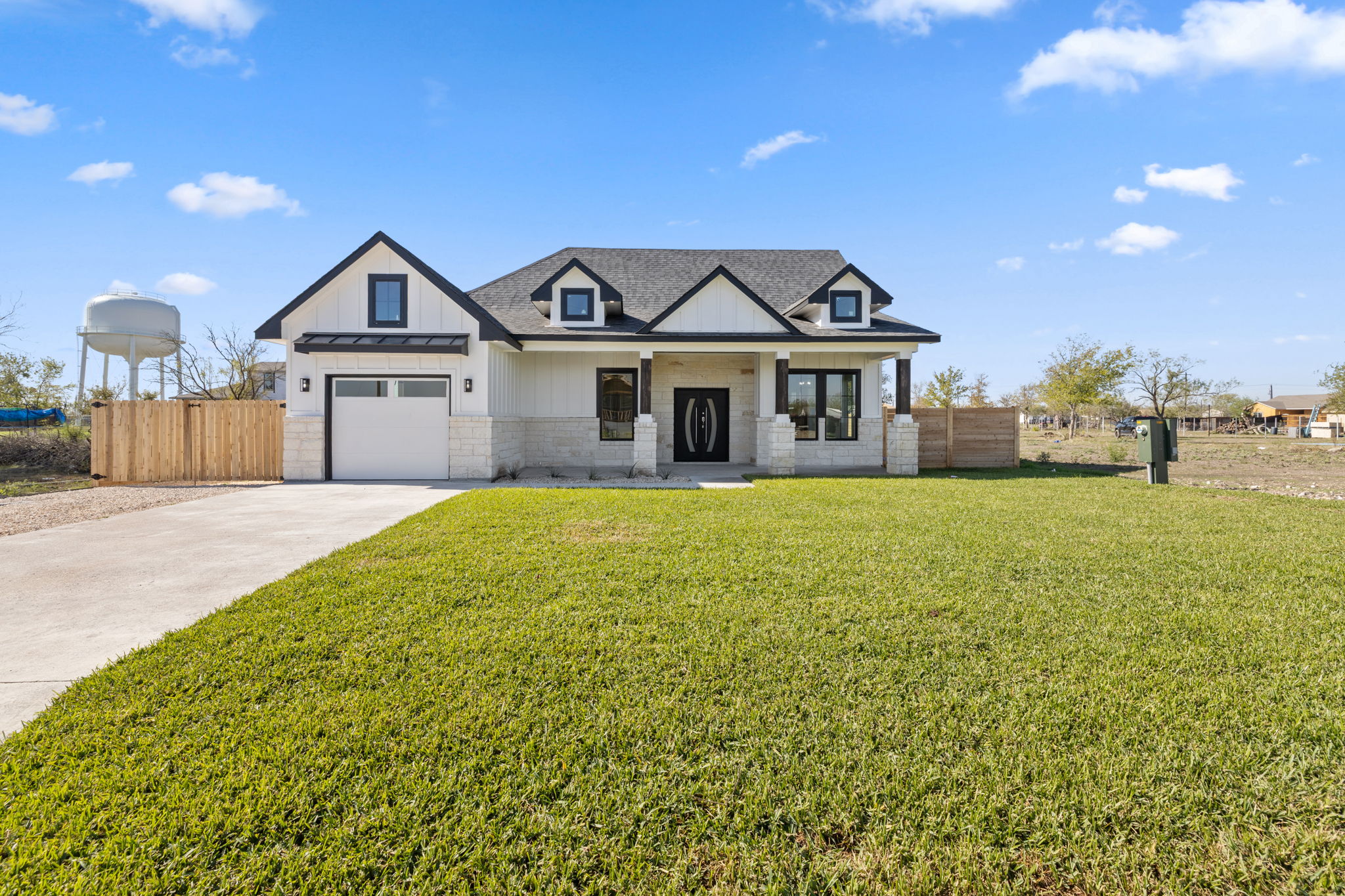 210 Jacaranda Drive Dale, TX 78616 - Photo 1 of 37 a view of a house with a big yard and large trees