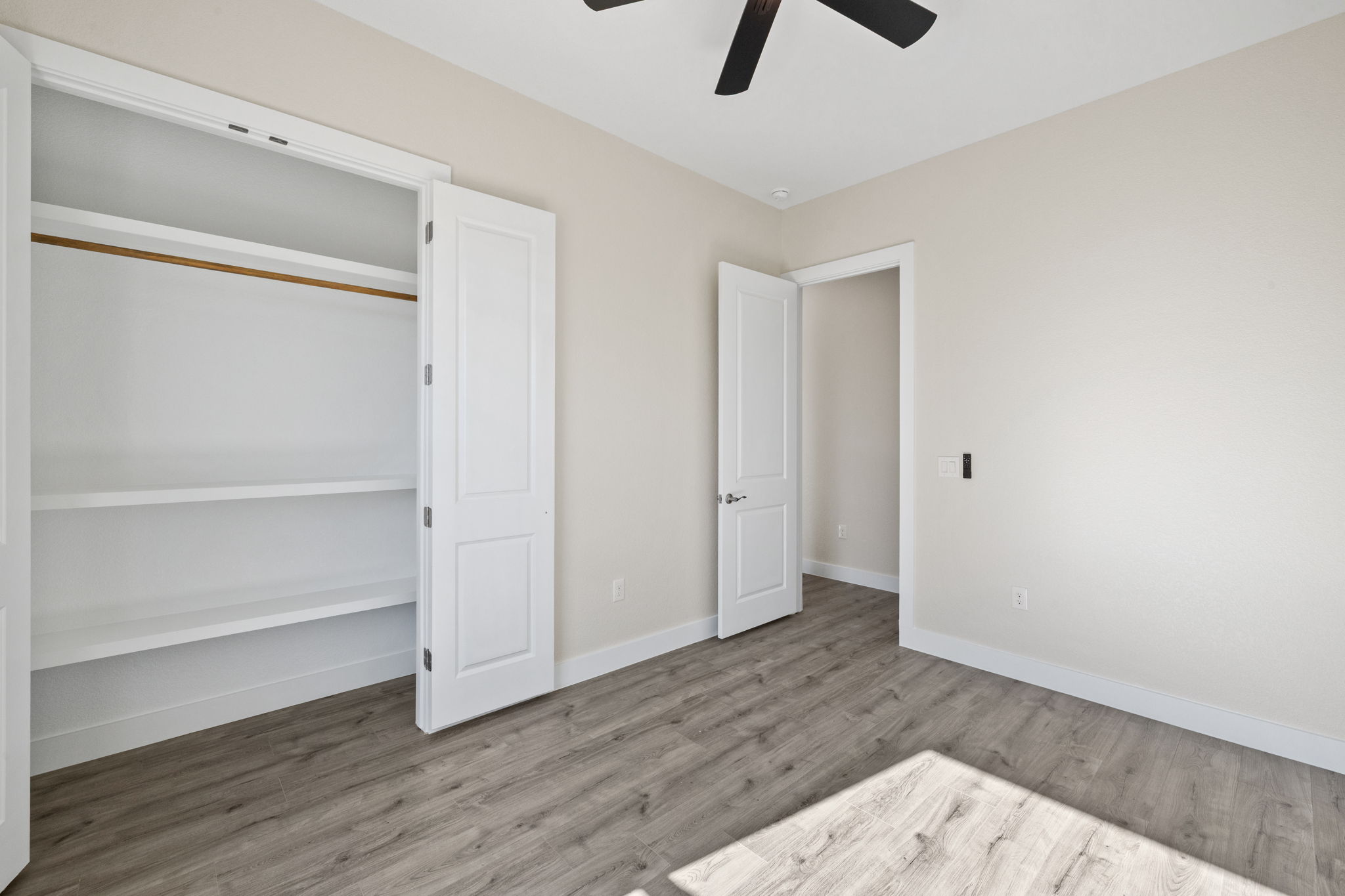 210 Jacaranda Drive Dale, TX 78616 - Photo 21 of 37 a view of an empty room with wooden floor