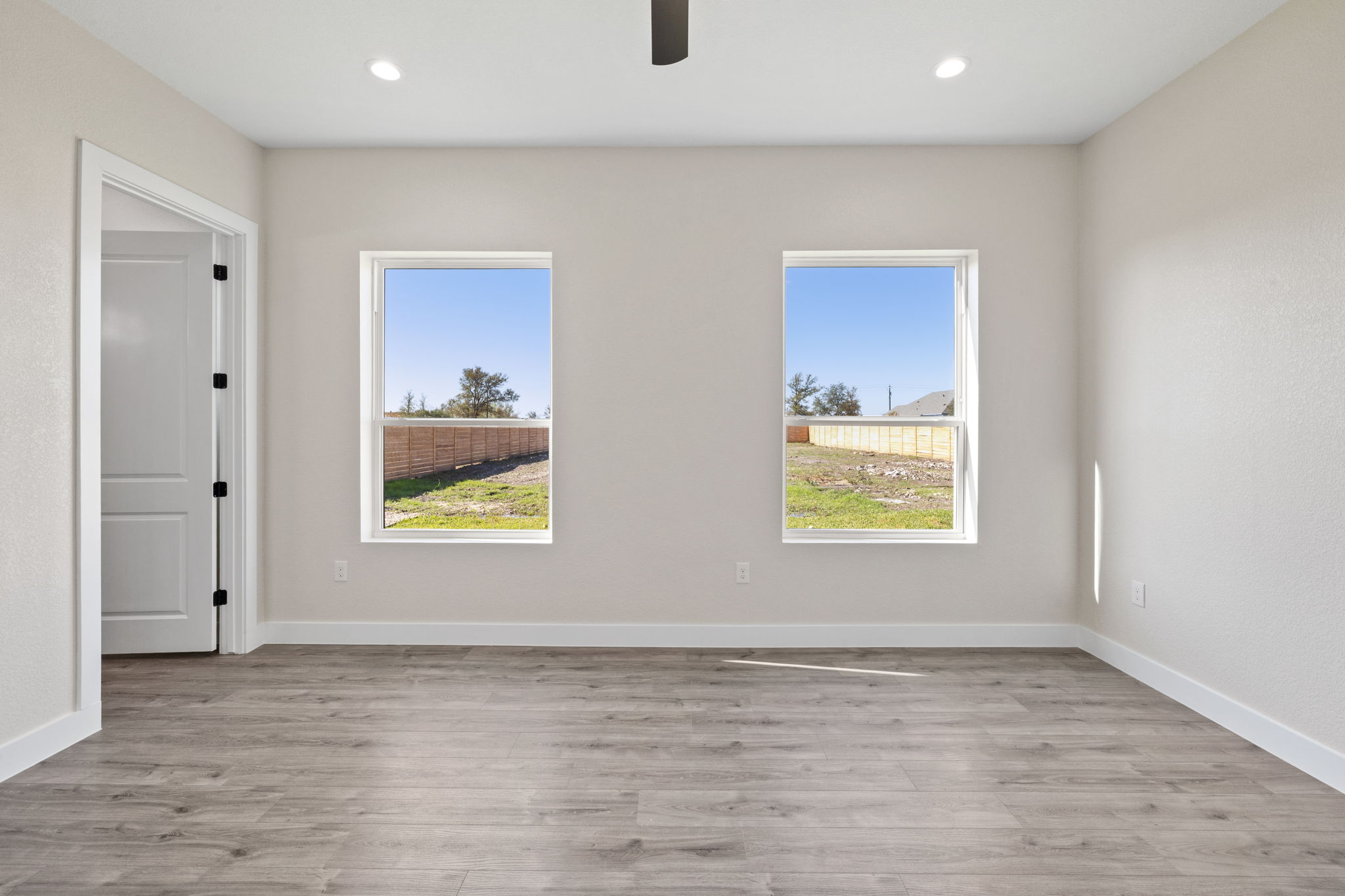 210 Jacaranda Drive Dale, TX 78616 - Photo 25 of 37 a view of an empty room with wooden floor and window