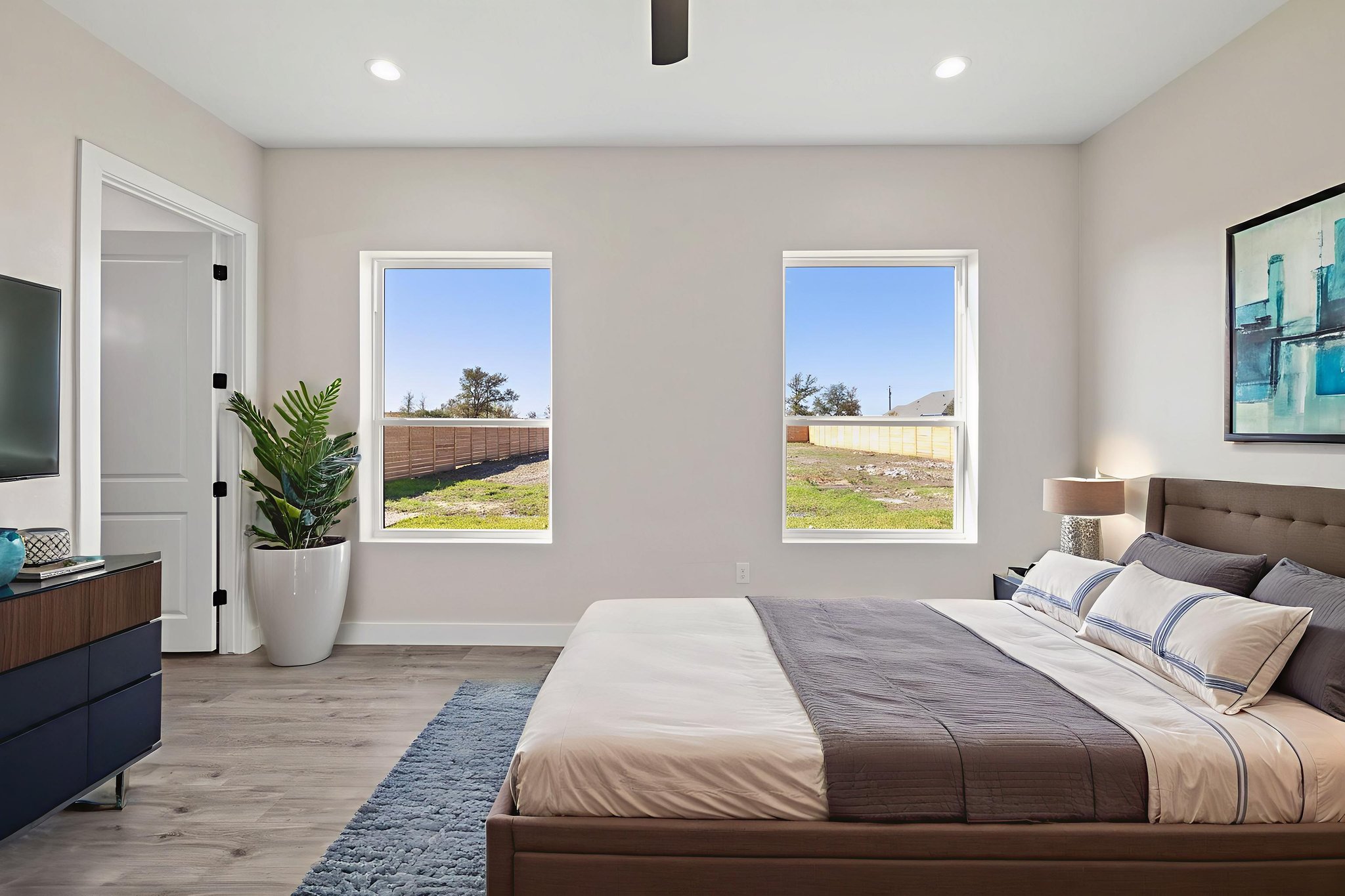 210 Jacaranda Drive Dale, TX 78616 - Photo 26 of 37 a bedroom with a bed and a potted plant