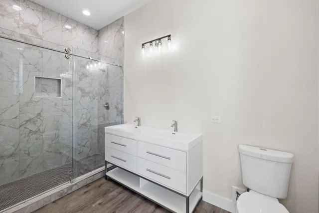 a bathroom with a toilet sink and shower