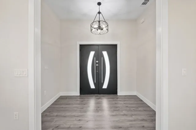 a view of a hallway with wooden floor