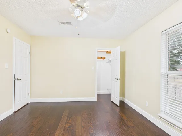 a view of walk in closet with empty racks