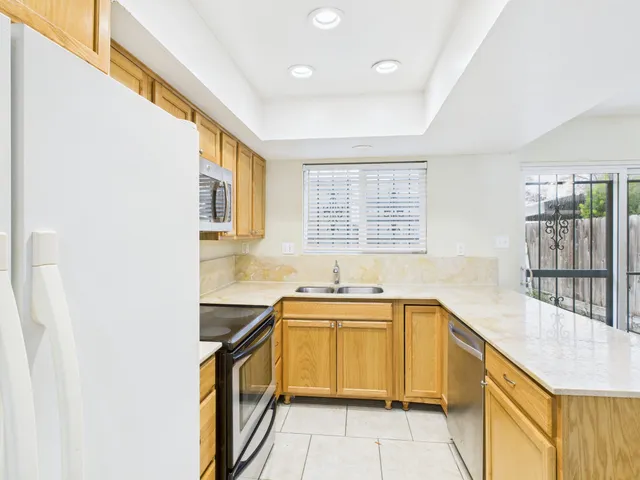 a kitchen with a sink stove and cabinets