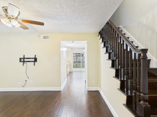 a view of a room with wooden floor