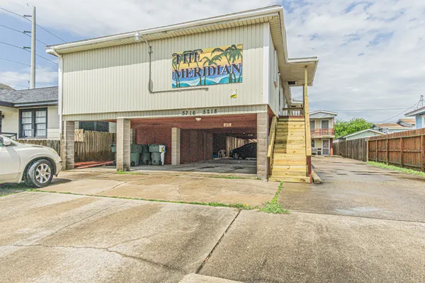 a view of a building with parking area