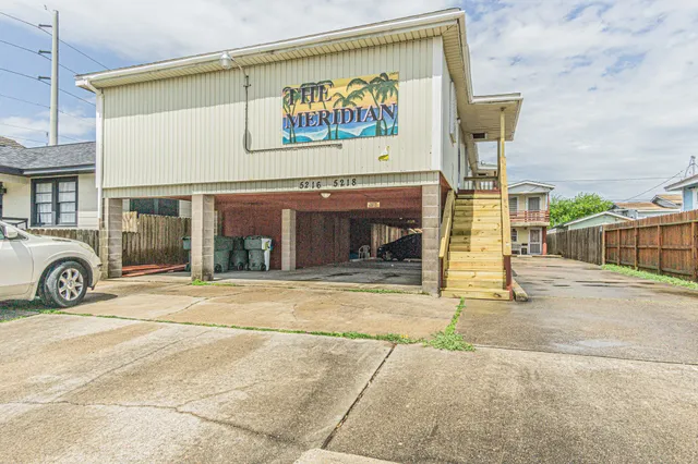 a view of a building with parking area