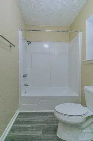 a bathroom with a toilet and a shower