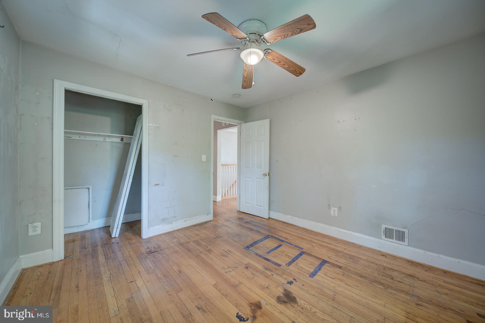 802 Modoc Lane Oxon Hill, MD 20745 - Photo 13 of 34 an empty room with wooden floor and ceiling fan
