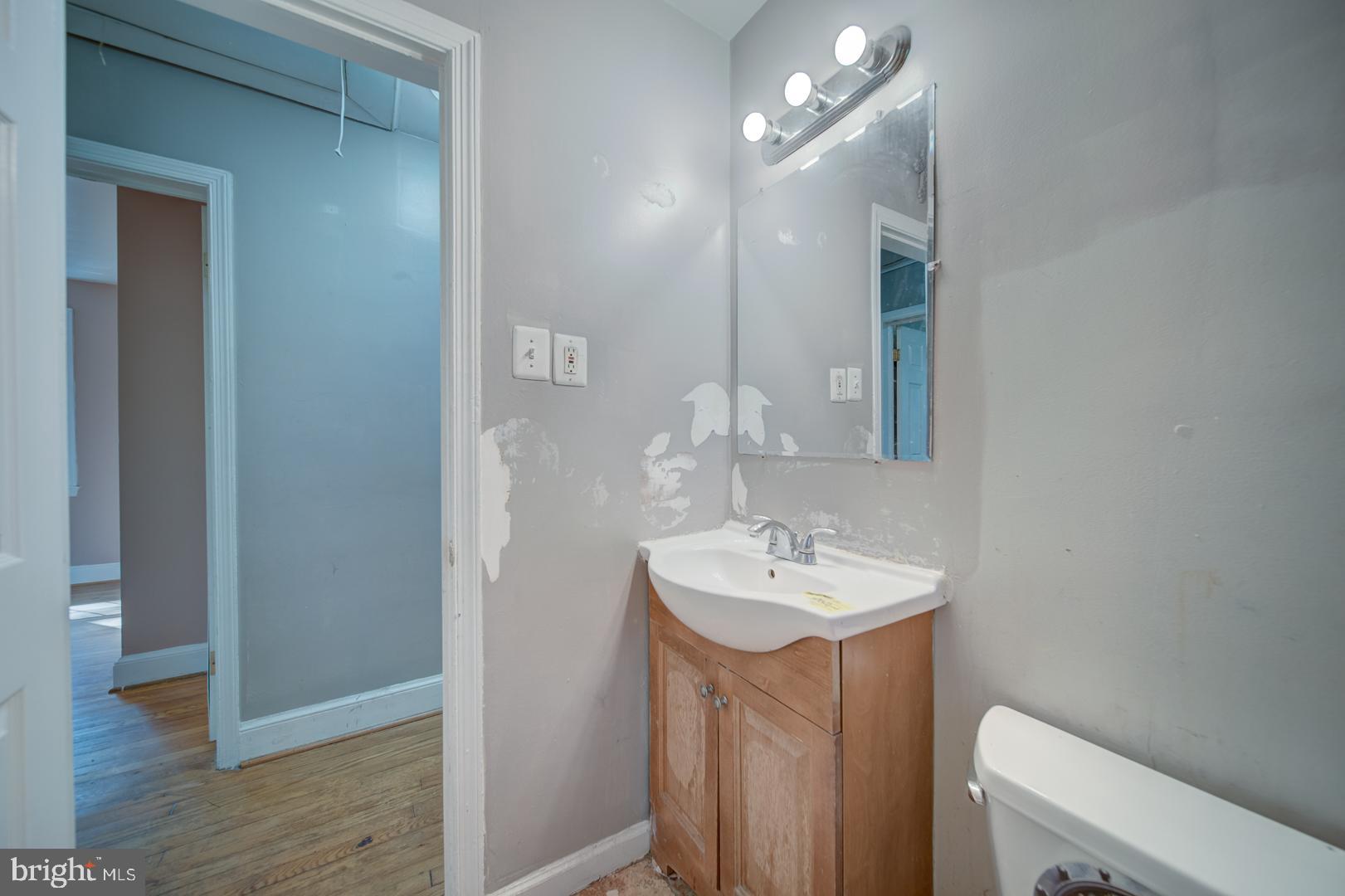 802 Modoc Lane Oxon Hill, MD 20745 - Photo 15 of 34 a bathroom with a sink a toilet and mirror