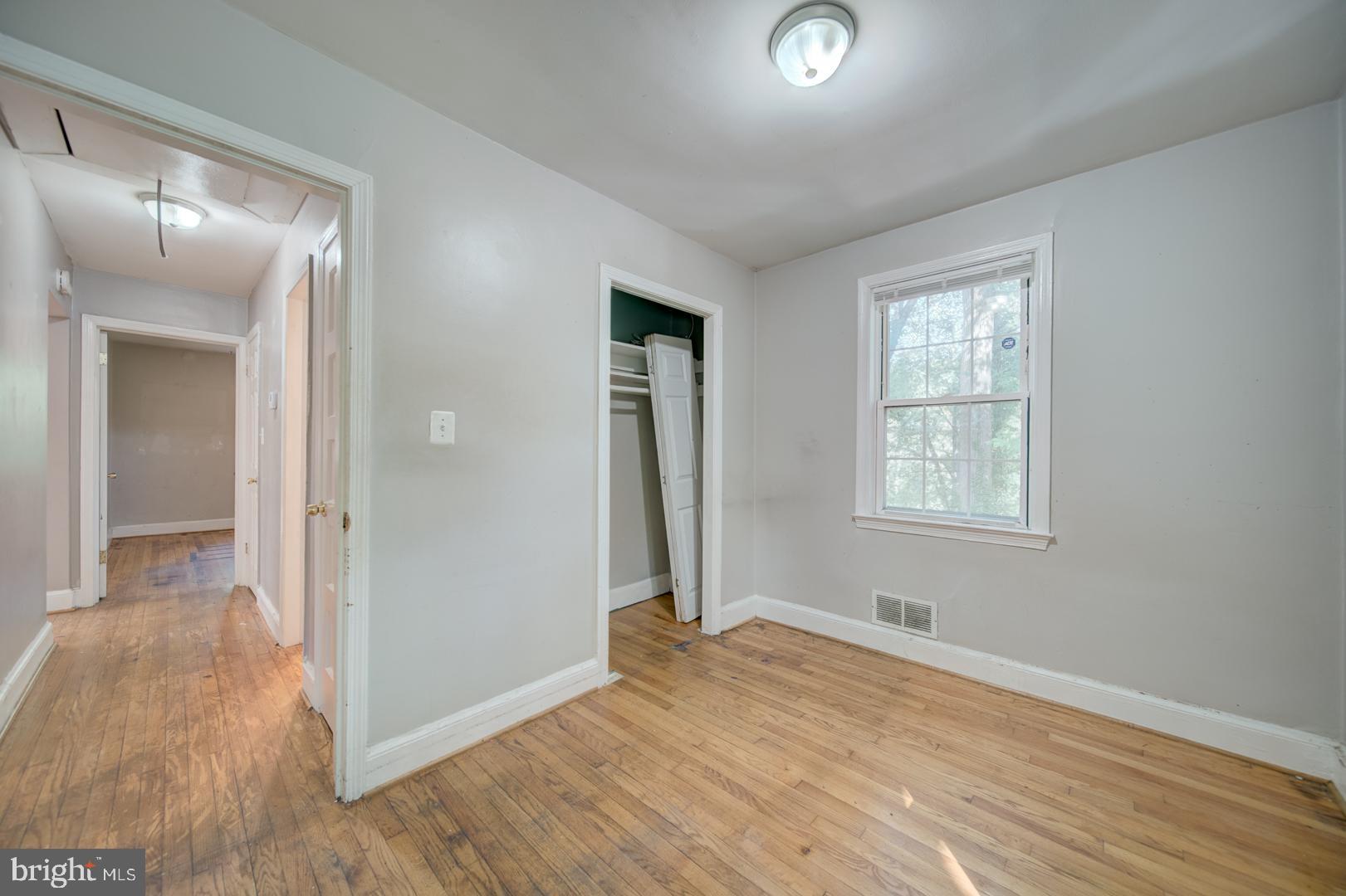 802 Modoc Lane Oxon Hill, MD 20745 - Photo 17 of 34 wooden floor in an empty room with a window
