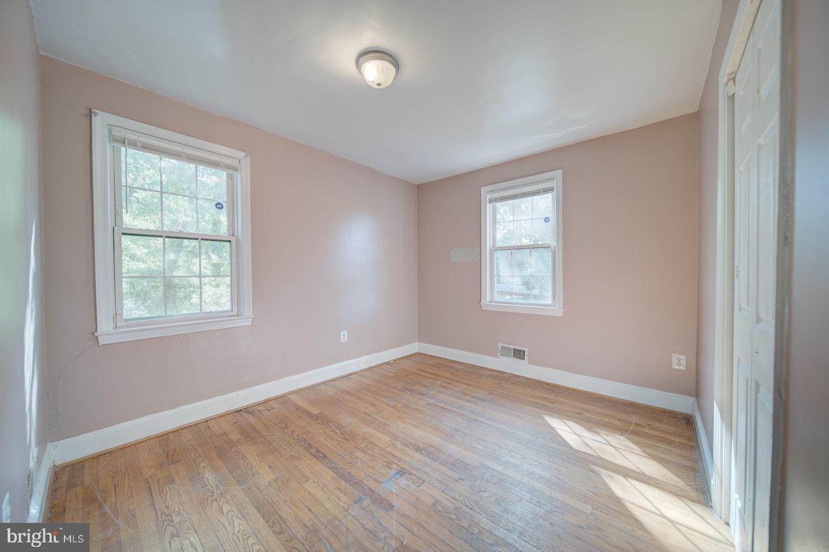 802 Modoc Lane Oxon Hill, MD 20745 - Photo 19 of 34 wooden floor in an empty room with a window