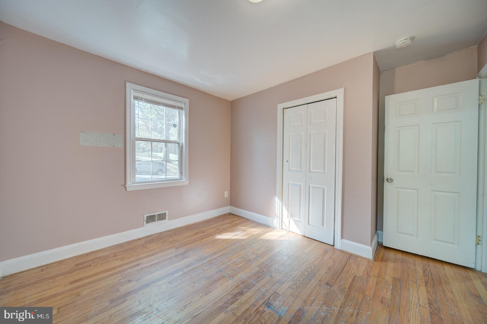802 Modoc Lane Oxon Hill, MD 20745 - Photo 20 of 34 an empty room with wooden floor and windows