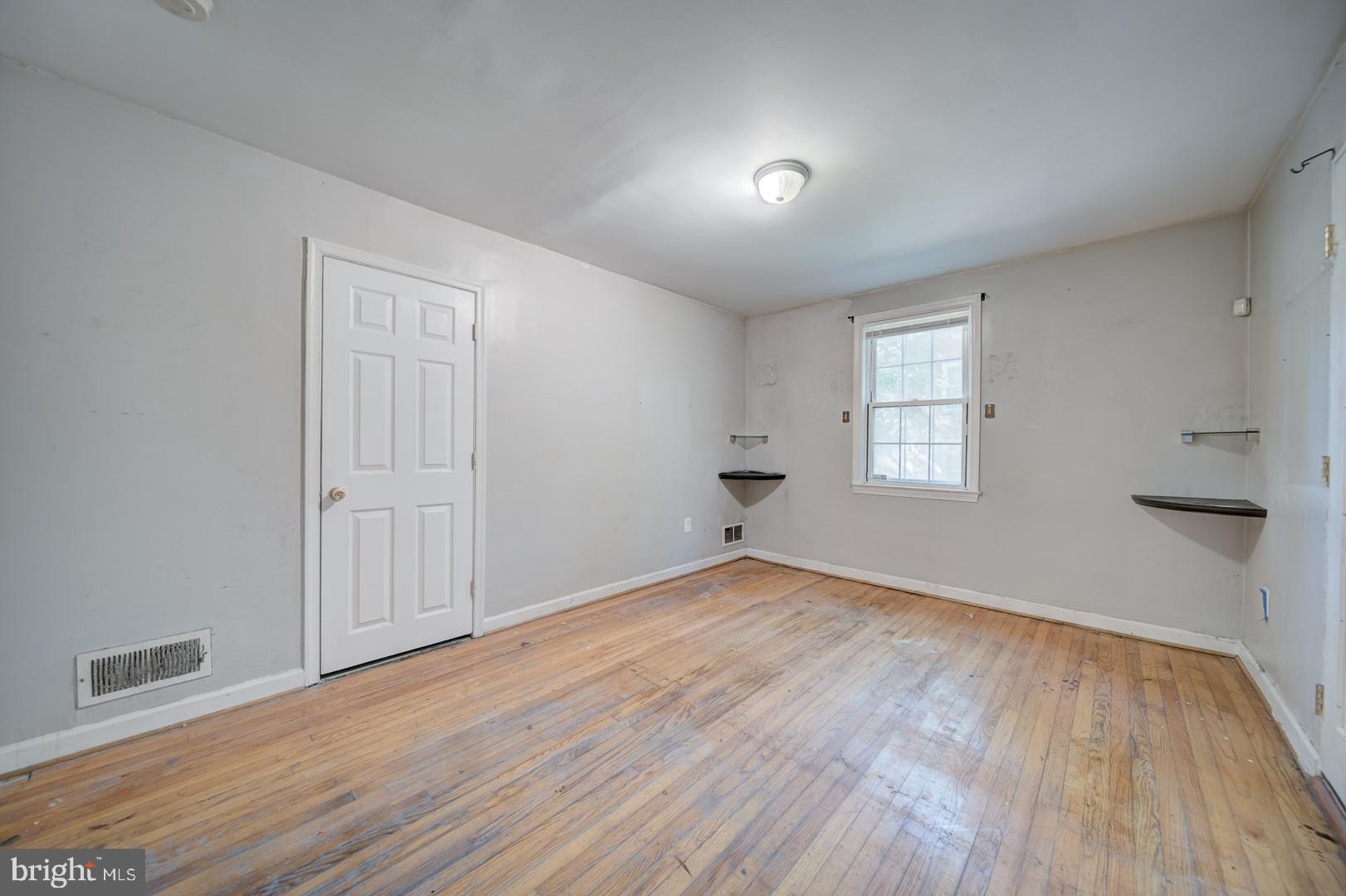 802 Modoc Lane Oxon Hill, MD 20745 - Photo 23 of 34 an empty room with wooden floor and windows